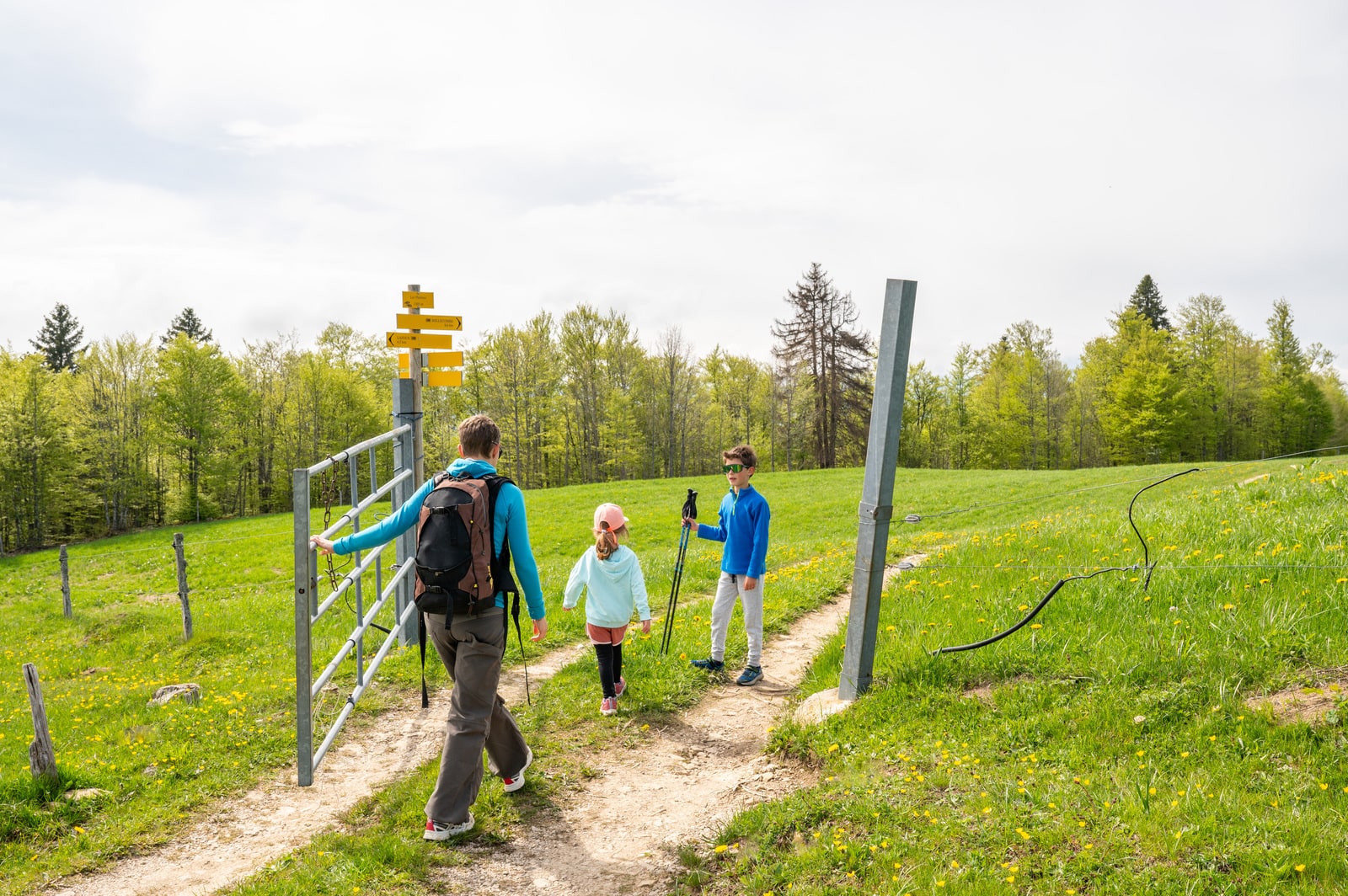 famille passe une barrière en randonnée