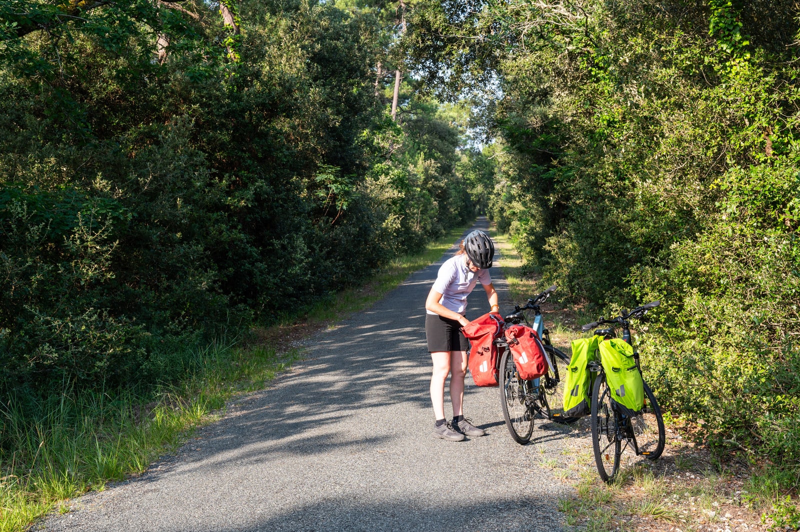 cycliste range sa sacoche sur son vélo